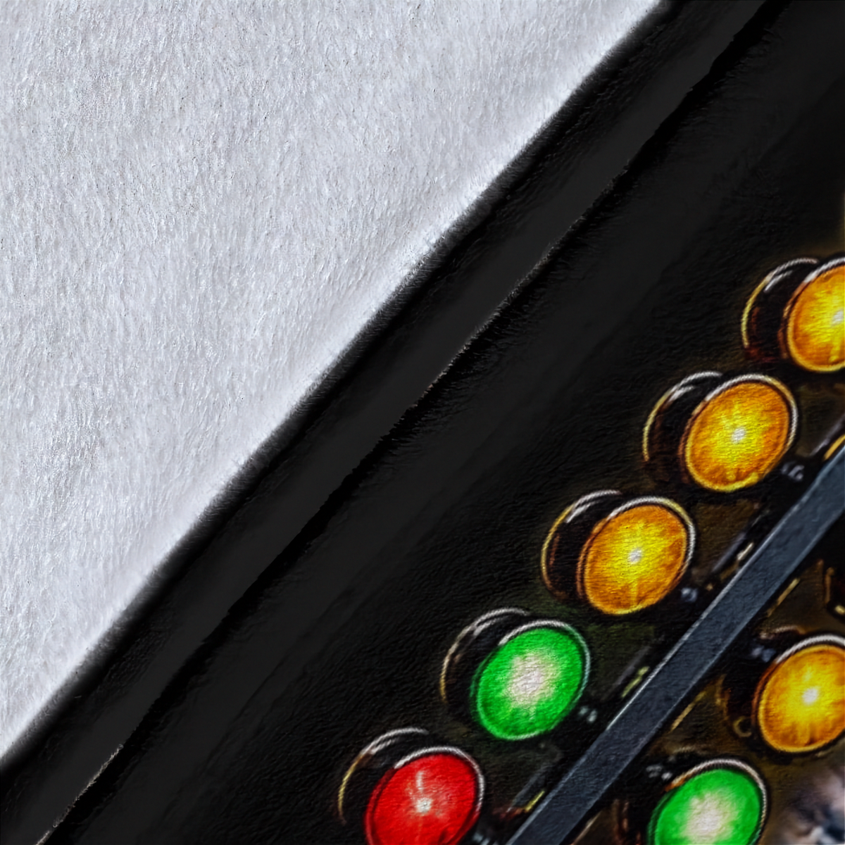 Close-up of a black electronic panel with illuminated red, green, and amber indicator lights against a textured light gray background.
