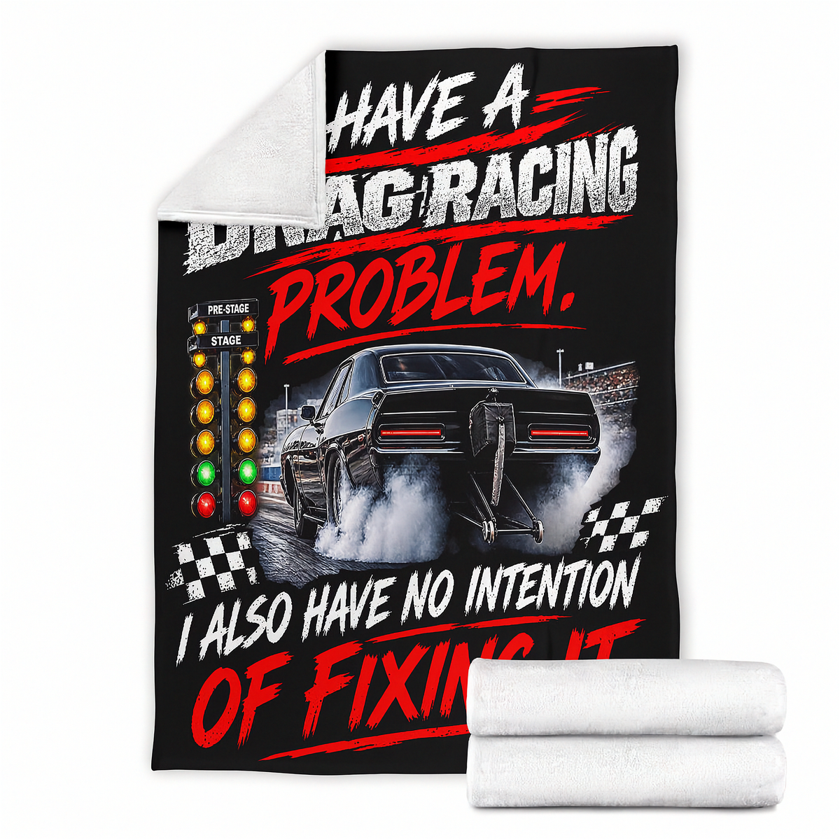 A black fleece throw blanket featuring a drag racing graphic with a black muscle car, a starting light sequence, and the text 'HAVE A DRAG RACING PROBLEM, I ALSO HAVE NO INTENTION OF FIXING IT.' A white sherpa lining is visible on the folded corner, and two rolled white blankets are shown in front on a white background.