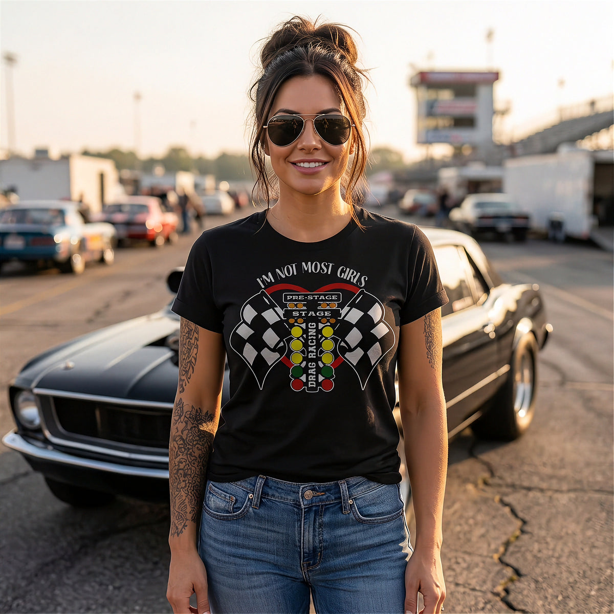 A bold and stylish apparel design featuring the text "I'm Not Most Girls" with drag racing graphics, printed on premium women's t-shirt.