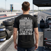 Man wearing a black t-shirt with drag racing-themed text on a racetrack.