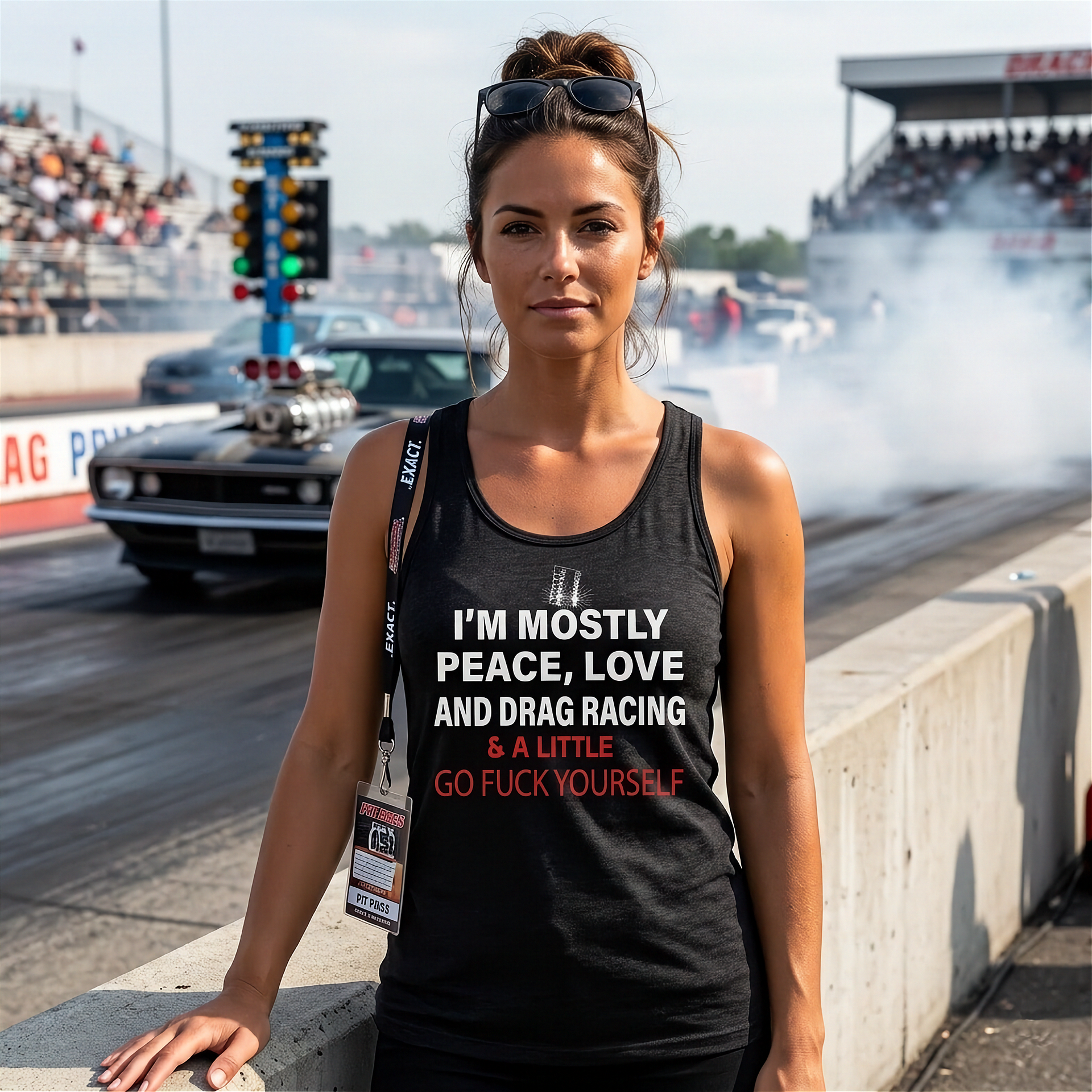 Woman wearing a tank top with a humorous text design at a drag racing event.