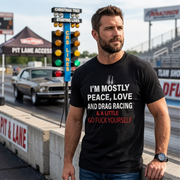 Man wearing a black t-shirt with drag racing quote text at a drag racing event