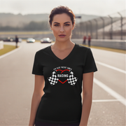Woman wearing a black t-shirt with racing design on a race track