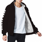 A man wearing a black zip-up hoodie with a gray sherpa lining and white 'DRAG RACING' lettering down one sleeve, layered over a white t-shirt and black pants, against a plain white background.