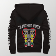 A black pullover hoodie shown from the back, featuring a large graphic print with the text 'I'M NOT MOST WOMEN' above a drag racing headlight design in red, yellow, green, and white. White text runs down both sleeves.