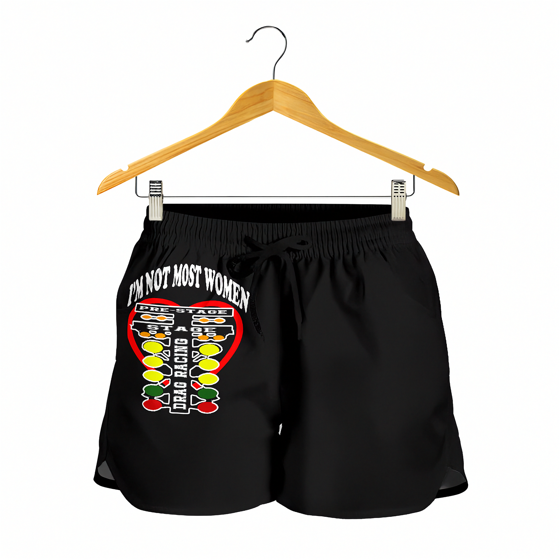Black women's athletic shorts with a graphic print of a drag racing checklist and the text 'I'M NOT MOST WOMEN' on the left leg, hanging from a wooden hanger against a white background.