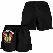 Black athletic shorts shown from two angles: a back view on the upper right and a front view on the lower left. The front view features a graphic with the text 'I'M NOT MOST WOMEN' above a stylized boxing ring design with yellow, red, and white elements.