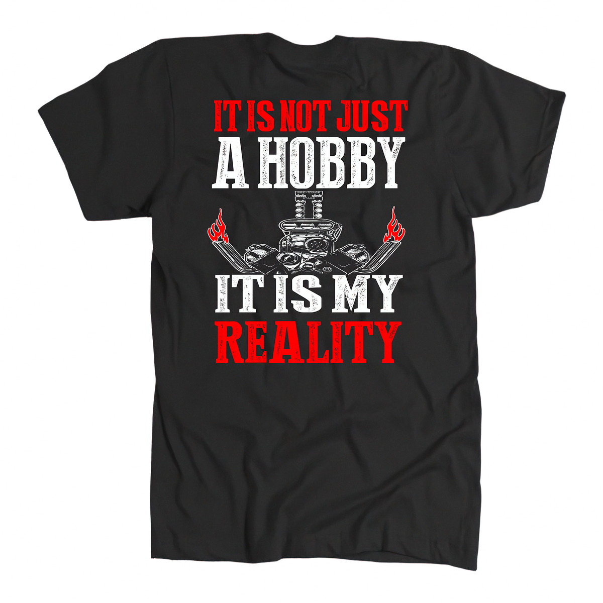 A black short-sleeve t-shirt with a graphic print on the front. The design features the text 'IT IS NOT JUST A HOBBY IT IS MY REALITY' in distressed white and red lettering, with a central illustration of a skull wearing a chef's hat and crossed tools, flanked by two hands holding red flags.