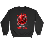 A black crewneck sweatshirt featuring a red and white graphic print on the front with the text 'JUST A WITCH WHO LOVES DRAG RACING' and paw prints, displayed on a solid white background.