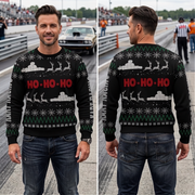 A man wearing a black Christmas sweater with a festive holiday graphic, shown in front and back views. The sweater features 'HO-HO-HO' in red text, white snowflakes and reindeer silhouettes, and green zig-zag accents.