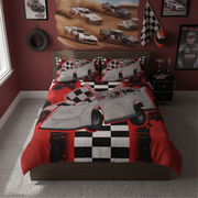 A racing-themed bedding set featuring a duvet cover and two pillowcases with a graphic print of a gray late model race car over a red, black, and white checkered pattern, shown on a bed in a styled bedroom.