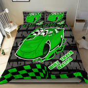 A racing-themed bedding set featuring a green race car graphic, black and green checkered patterns, and the text 'DIRT TRACK RACING' on a bed in a bedroom setting.