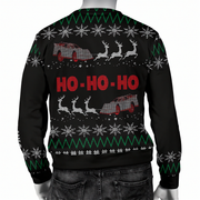 A black Christmas sweater with a festive holiday pattern, featuring red 'HO-HO-HO' text, white snowflakes, green zig-zag stripes, and red-and-white sledding cars with reindeer. The image shows the back view of the sweater on a mannequin torso against a white background.