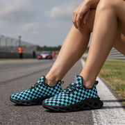 Person wearing blue and black checkered shoes on a race track