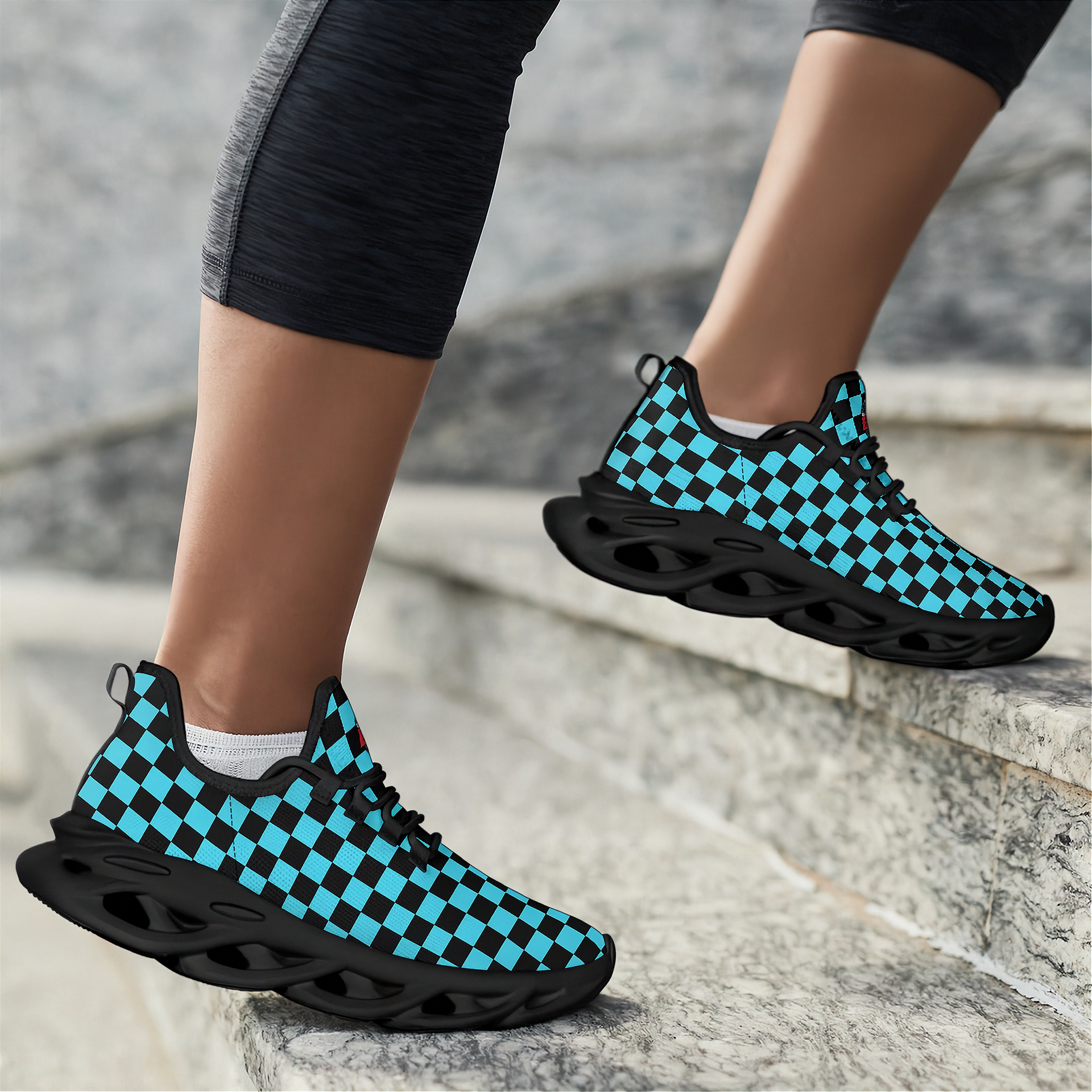 Checkered black and blue sneakers worn on a stone staircase