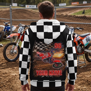 Man wearing a custom motocross sherpa jacket beside dirt bikes, showing the personalized back and checkered sleeves and hood.