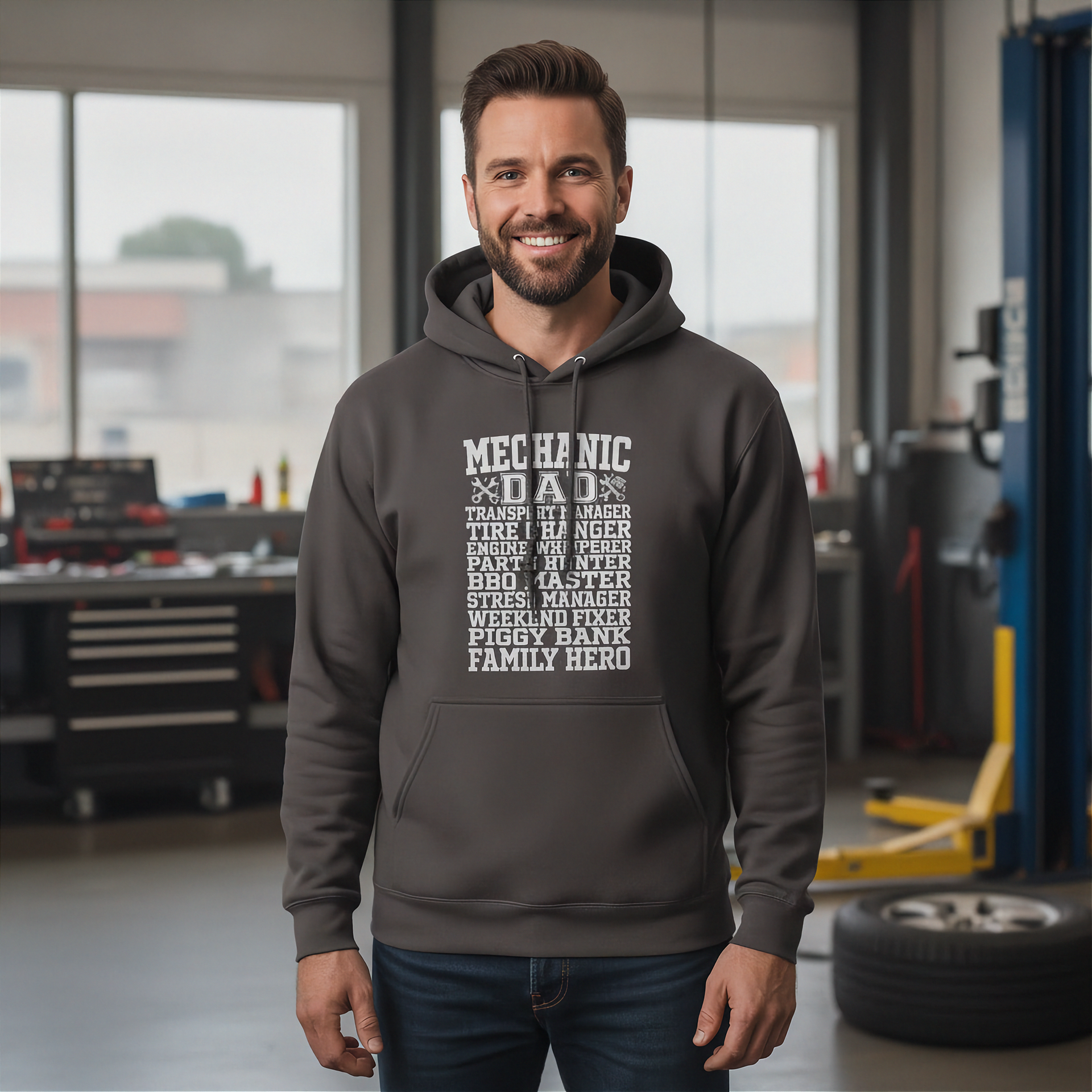 Man wearing a hoodie with mechanic dad in a garage setting