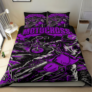 A motorcycle-themed bedding set featuring a black and purple graphic print with the word 'MOTOCROSS' and illustrated riders and bikes, shown on a bed in a bedroom setting.