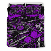 A bedding set featuring a duvet cover and two pillowcases with a high-contrast graphic print of motocross riders in purple, black, and white, with the word 'MOTOCROSS' printed across the top.