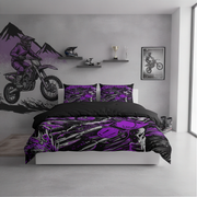 A bed dressed in a motocross-themed bedding set with a bold purple, black, and white graphic print, set in a modern bedroom with a matching wall mural.