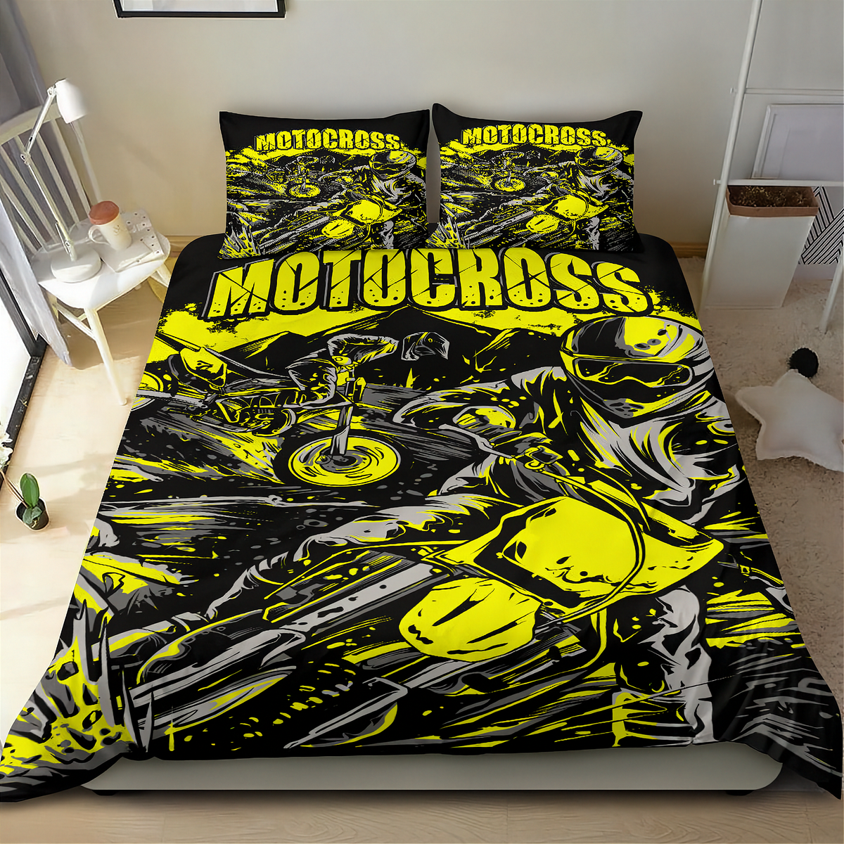 A motocross-themed bedding set featuring a duvet cover and two pillowcases with a bold black, yellow, and gray graphic print of a motorcycle racer, shown on a bed in a bedroom setting.
