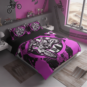 A kids' bedding set featuring a motocross theme, displayed on a bed in a styled bedroom. The set includes a duvet cover and two matching pillowcases with a graphic of a dirt bike rider in black and bright pink, set against a background of black and white stripes.