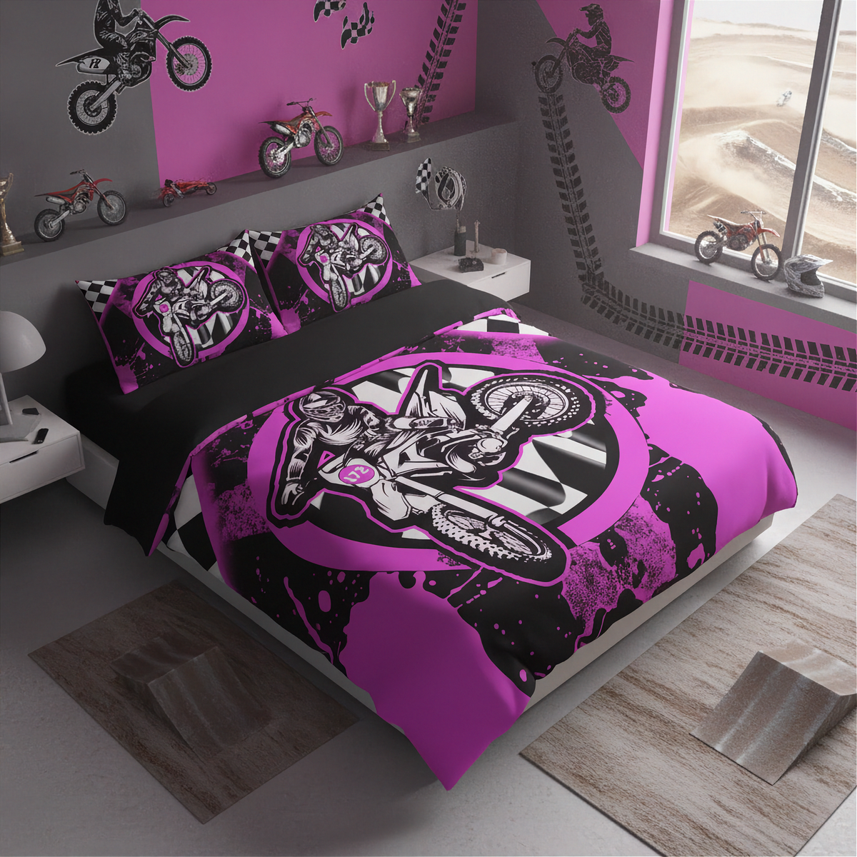 A kids' bedding set featuring a motocross theme, displayed on a bed in a styled bedroom. The set includes a duvet cover and two matching pillowcases with a graphic of a dirt bike rider in black and bright pink, set against a background of black and white stripes.