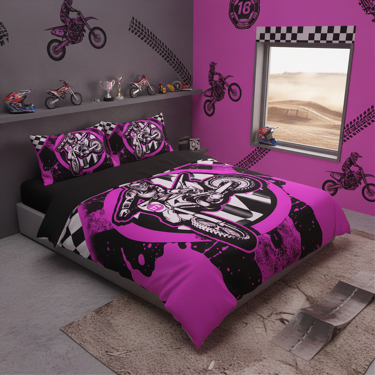 A kids' bedroom featuring a motocross-themed bedding set with a duvet cover and two pillowcases in vibrant pink, black, and white. The room has matching pink and gray walls decorated with motocross decals, a window looking out onto a dusty track, and a shelf with small dirt bike figurines.