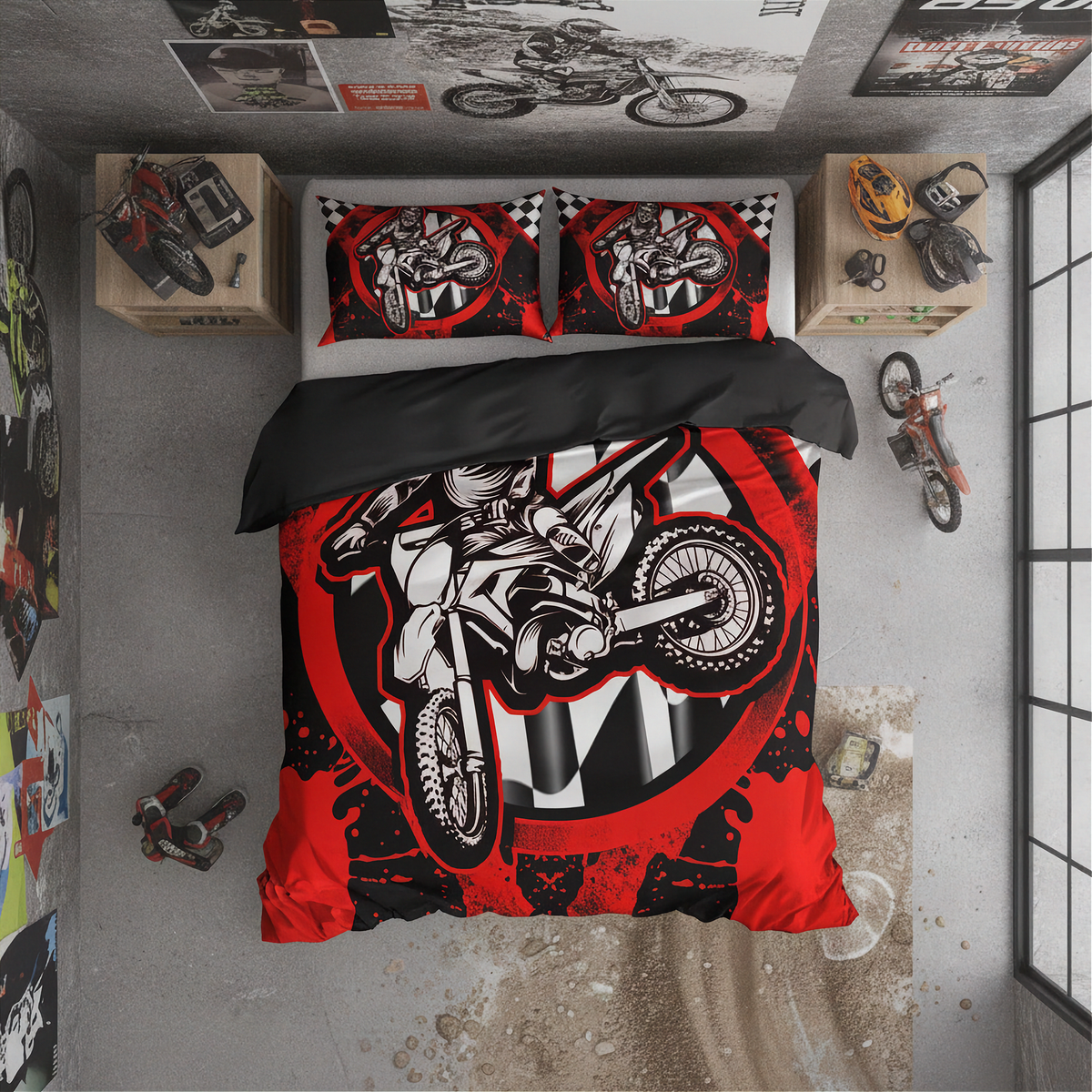 A top-down view of a bed styled in a motocross-themed bedroom, featuring a red, black, and white duvet cover and two matching pillowcases with a graphic of a dirt bike rider. The room has a concrete floor and walls decorated with motorcycle posters and models.