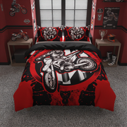 A motocross-themed bedding set featuring a duvet cover and two pillowcases with a bold red, black, and white graphic of a rider on a dirt bike over a checkered flag design, displayed in a red and black themed bedroom.