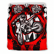 A bedding set featuring a duvet cover and two matching pillowcases with a high-contrast graphic print of a motocross rider on a dirt bike over a red, black, and white checkered background.