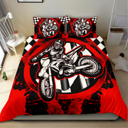 A motocross-themed bedding set featuring a duvet cover and two pillowcases with a bold graphic of a rider on a dirt bike over a red, black, and white checkered background, shown on a bed in a bedroom.