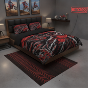 A bed dressed in a red, black, and gray motocross-themed bedding set with matching pillowcases, styled in a dark gray bedroom with motorcycle wall art, a neon sign, and a tire-pattern rug.