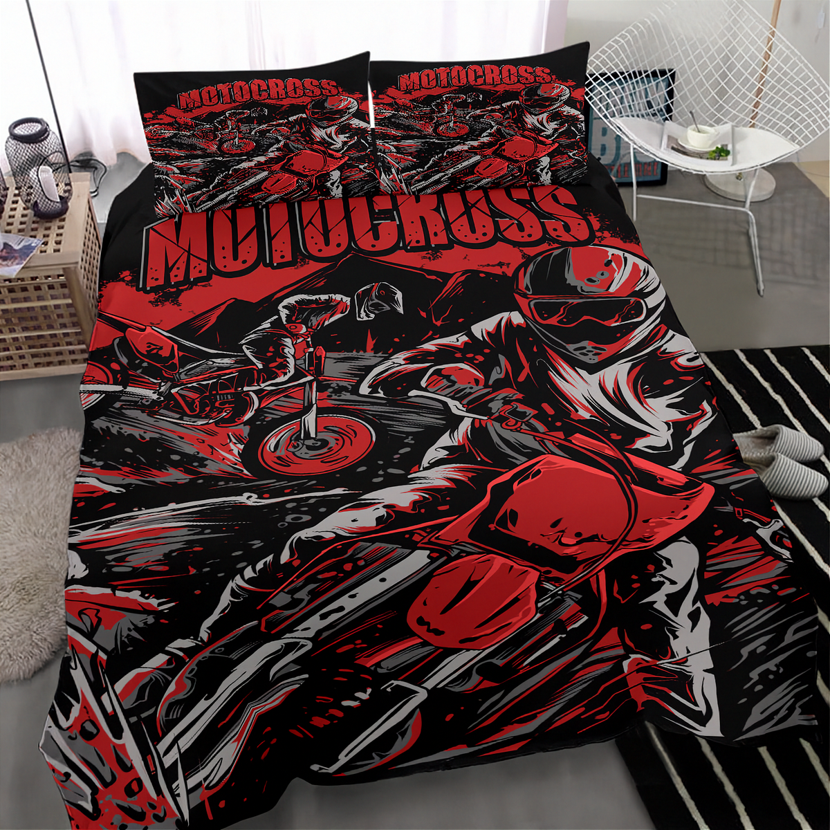 A motocross-themed bedding set featuring a duvet cover and two pillowcases with a bold red, black, and gray graphic print of a rider and motorcycles, shown on a bed in a modern bedroom setting.