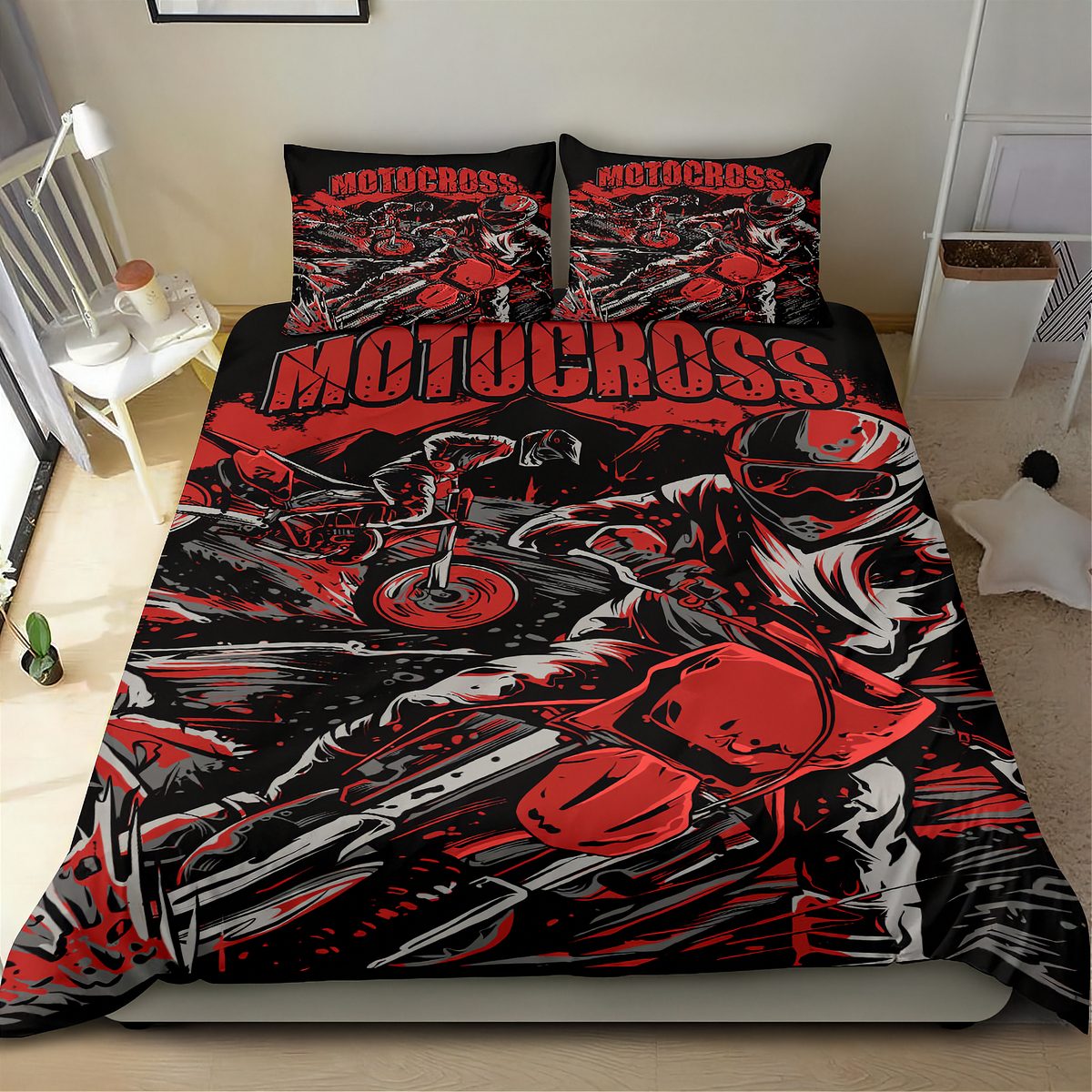 A bed dressed in a motocross-themed bedding set with a duvet cover and two pillowcases, featuring a bold red, black, and white graphic print of a motorcycle racer and the word 'MOTOCROSS' across the top. The bed is shown in a bedroom setting.