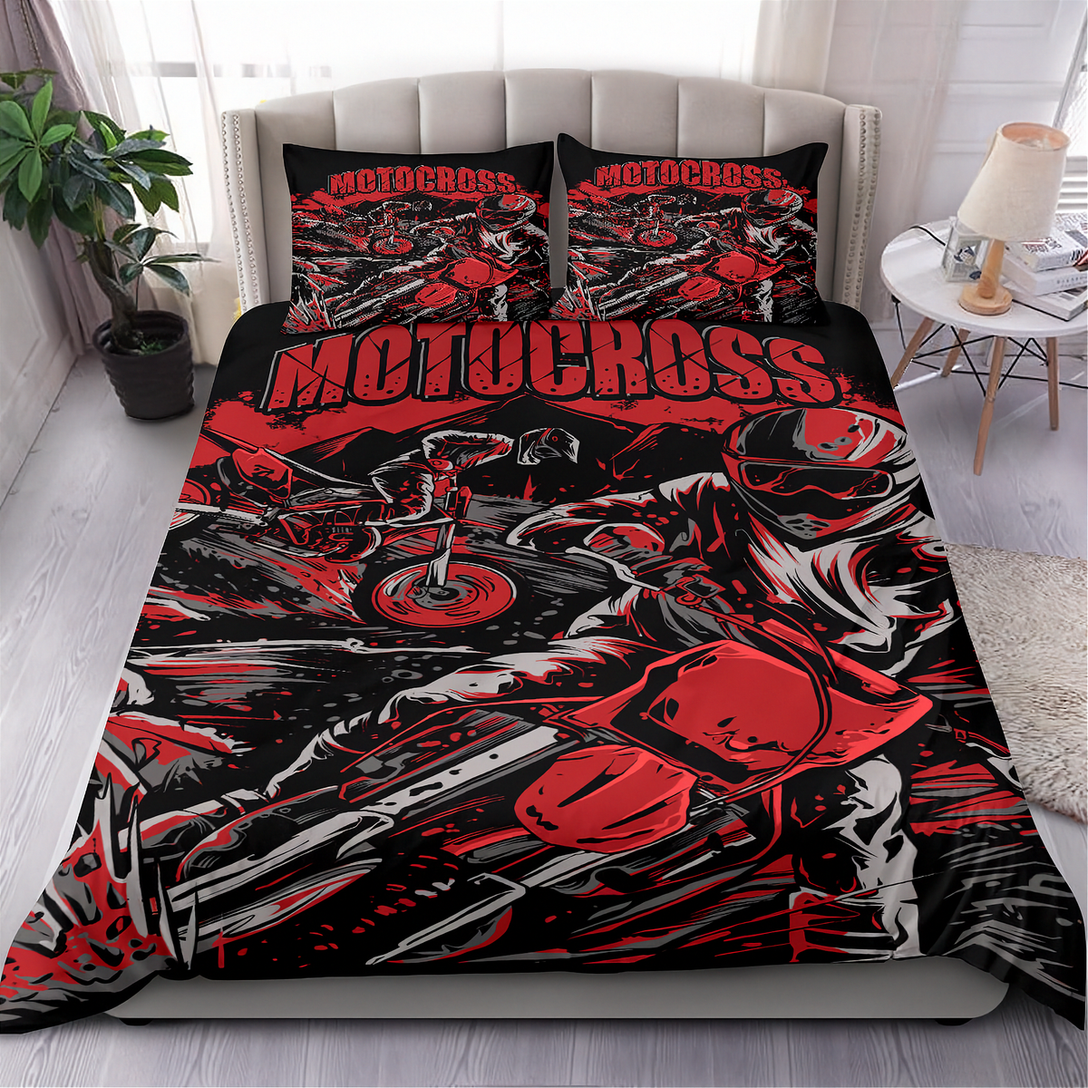 A bed dressed in a motocross-themed bedding set with a duvet cover and two matching pillowcases, shown in a styled bedroom setting with a headboard, side table, lamp, and plant.