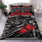 A motocross-themed bedding set featuring a duvet cover and two matching pillowcases with a bold red, black, and white graphic print of a motorcycle racer, styled on a bed in a modern bedroom setting.