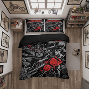 A top-down bedroom scene showing a bed dressed in a black, white, and red motocross-themed bedding set with matching pillowcases. The room includes wood floors, wall art with bicycles, shelves with small bike decor, and a window above the bed.