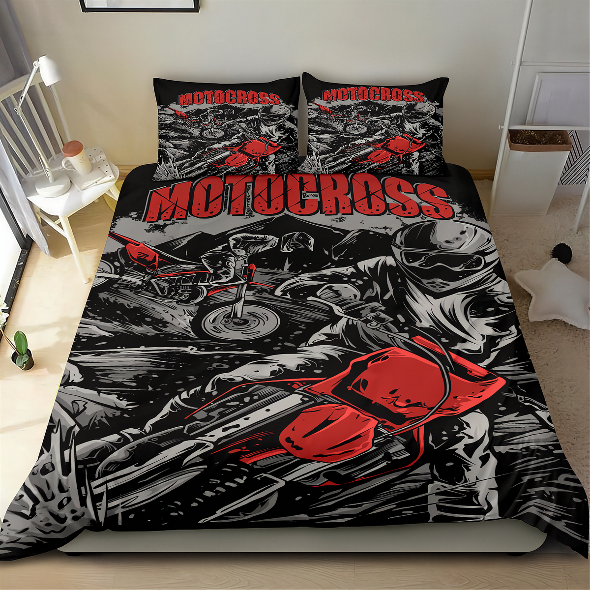 A motocross-themed bedding set featuring a duvet cover and two pillowcases with a bold black, white, and red graphic print of a rider and motorcycle, shown on a bed in a bedroom setting.