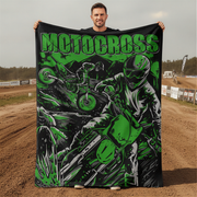 Man holding a 'Motocross' themed blanket with graphics of a rider on a dirt bike in an outdoor setting.