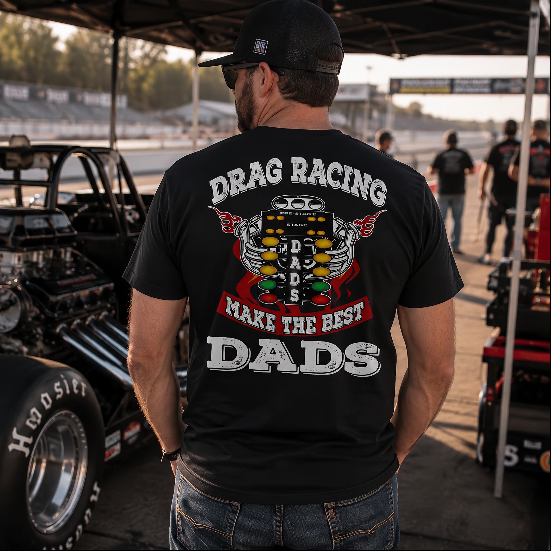 Motorsports apparel featuring the quote "Drag Racing Dads Make The Best Dads," available in premium tees, triblends, and hoodies for the father who loves the track.