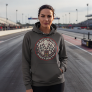 Woman wearing a hoodie with a drag racing graphic on a race track
