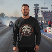 Man wearing a black sweatshirt with a graphic design on a drag racing track