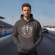 Man wearing a gray hoodie with a graphic design on a race track