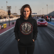 Woman wearing a black hoodie with a graphic design on a drag racing track
