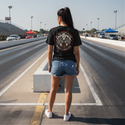 Woman wearing a black t-shirt with a graphic design on a racetrack