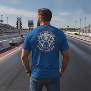 Man wearing a blue t-shirt with a graphic design on a race track