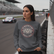 Woman wearing a sweatshirt with a racing theme on a race track background
