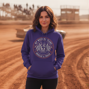Woman wearing a purple hoodie with a track-themed design on a dirt track background