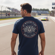 Man wearing a navy blue t-shirt with a graphic design on a race track